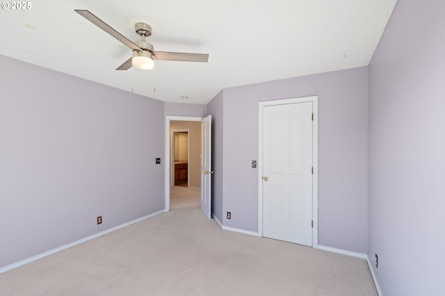 unfurnished bedroom with ceiling fan and light colored carpet