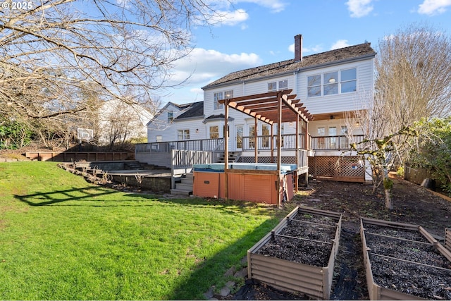 back of property with a deck, a yard, a hot tub, and a pergola