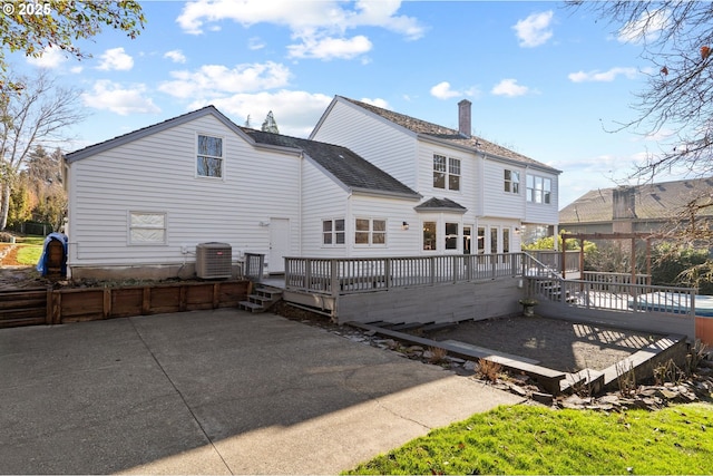 back of property featuring central AC and a deck