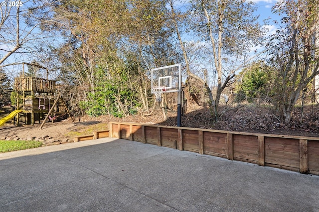 view of sport court featuring a playground