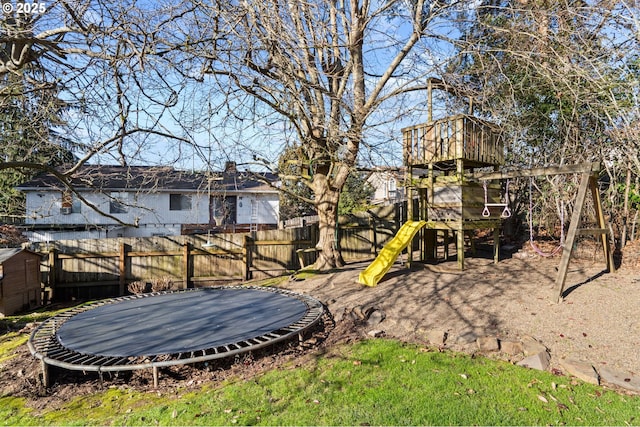 view of yard with a playground and a trampoline