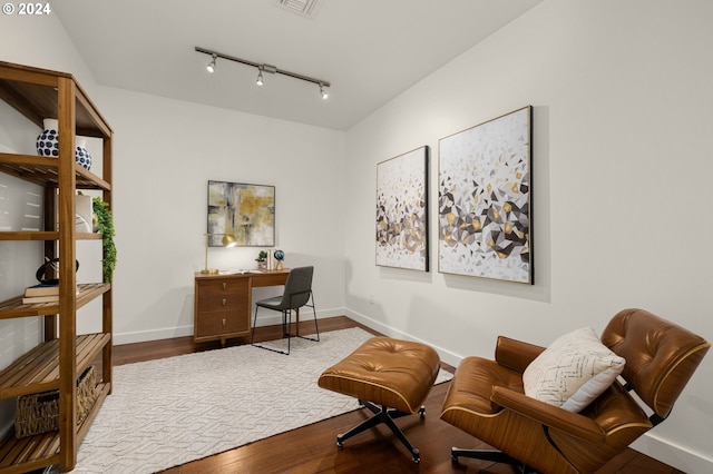 office featuring wood-type flooring and rail lighting