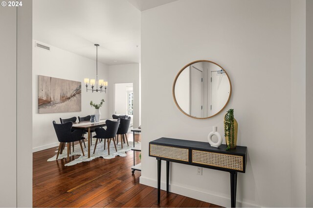 interior space with a chandelier and dark hardwood / wood-style floors