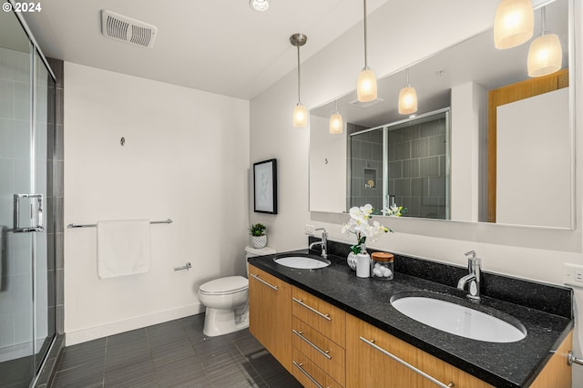 bathroom featuring vanity, a shower with shower door, toilet, and tile patterned floors