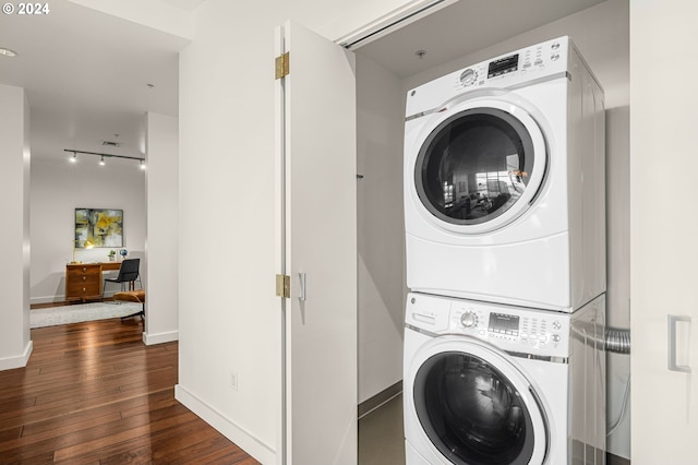 laundry room with stacked washer and clothes dryer and dark wood-type flooring