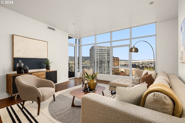 living room featuring wood-type flooring and plenty of natural light