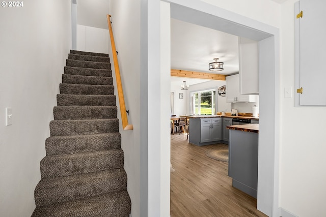 stairs featuring hardwood / wood-style floors