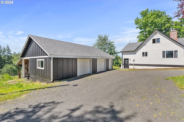 view of property exterior featuring a garage and an outbuilding