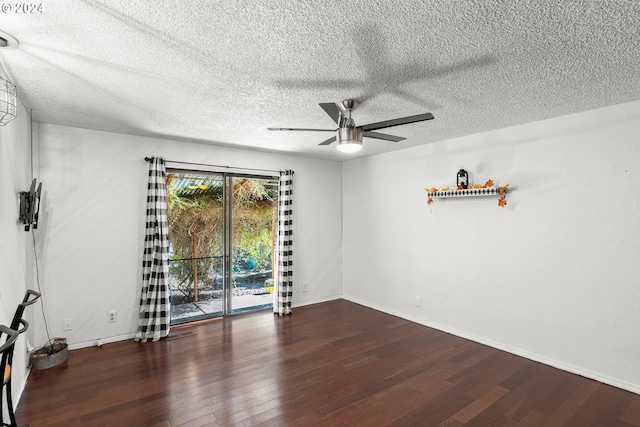 spare room with ceiling fan, a textured ceiling, and dark hardwood / wood-style floors