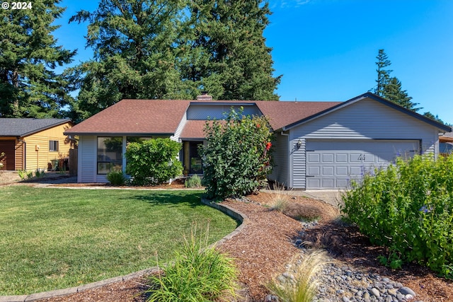 single story home with a garage and a front lawn