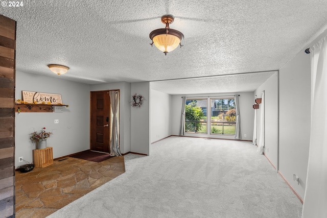 interior space with a textured ceiling and carpet