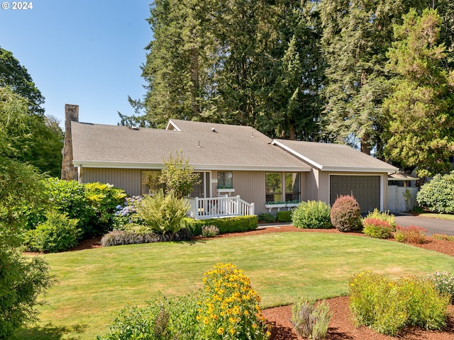 ranch-style house featuring a front lawn and a garage