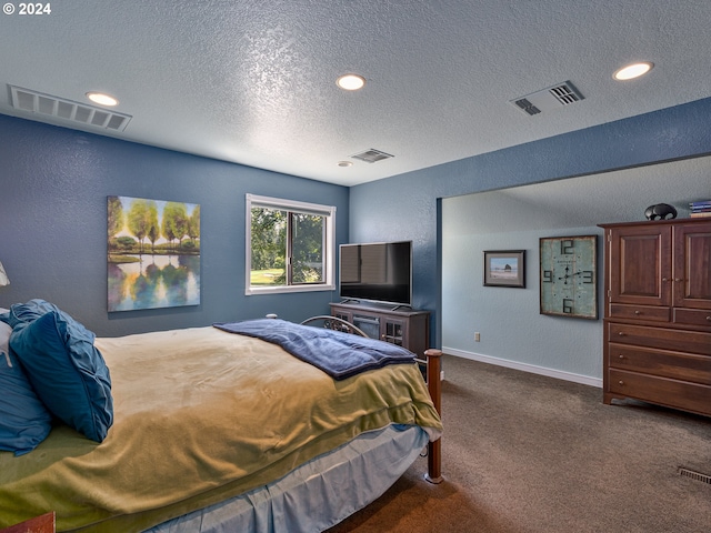 carpeted bedroom with a textured ceiling