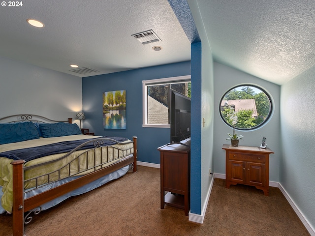 carpeted bedroom featuring a textured ceiling and vaulted ceiling