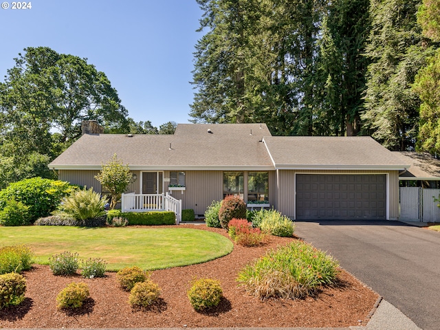 ranch-style home with a front yard and a garage