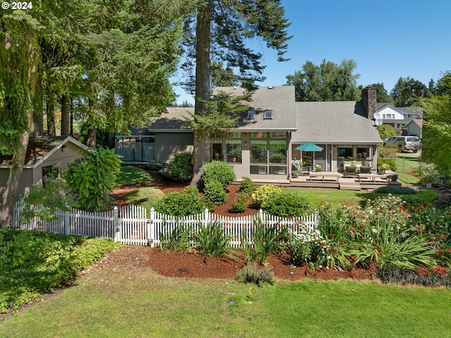 back of house with a lawn, an outdoor hangout area, and a wooden deck