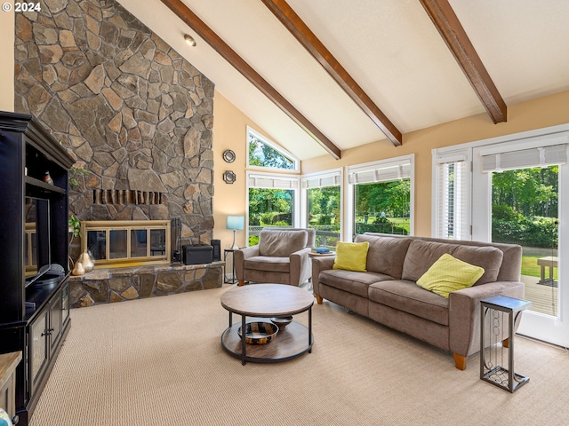 living room featuring a healthy amount of sunlight, a stone fireplace, high vaulted ceiling, and beam ceiling