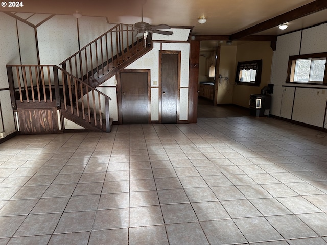 interior space featuring beamed ceiling and ceiling fan