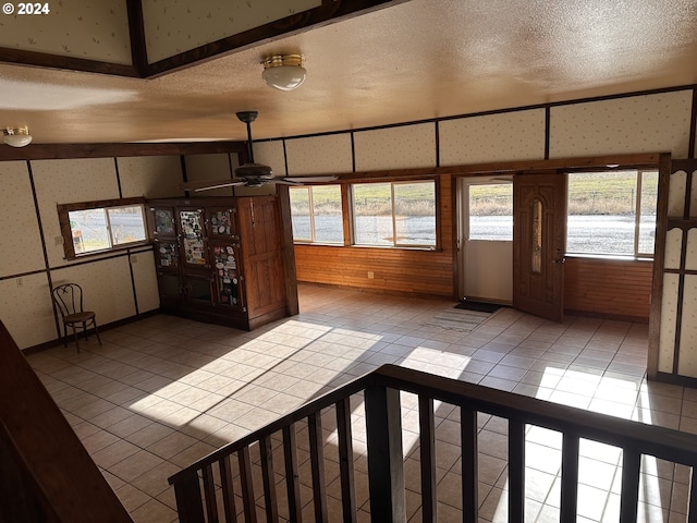 interior space featuring light tile patterned flooring and a textured ceiling