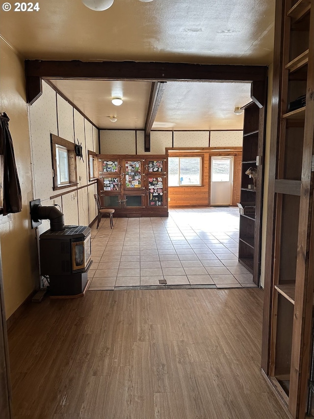 interior space featuring beam ceiling, a textured ceiling, and hardwood / wood-style flooring