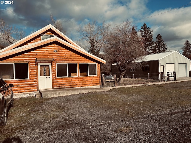 log home with an outbuilding and a garage