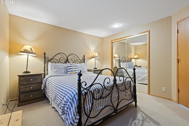 bedroom with light colored carpet and a closet