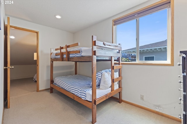 carpeted bedroom with a textured ceiling