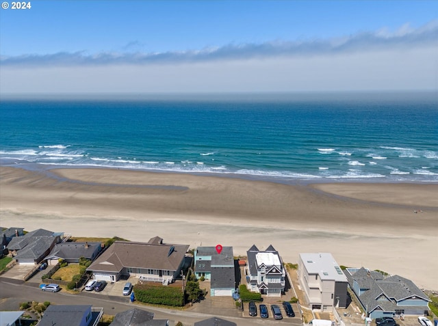 drone / aerial view featuring a water view and a view of the beach