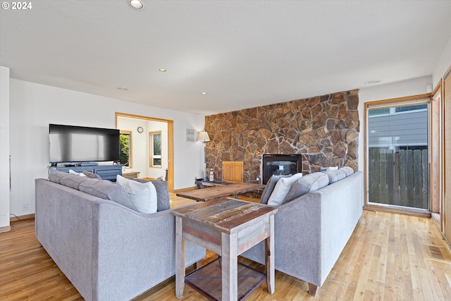 living room with a fireplace and light hardwood / wood-style floors