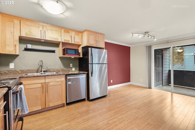 interior space featuring rail lighting, wood-type flooring, and ornamental molding