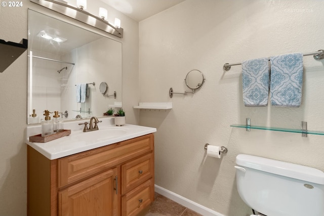 bathroom with a shower, tile patterned flooring, vanity, and toilet