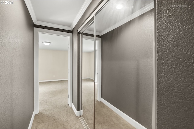 corridor featuring crown molding and light carpet