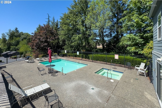 view of swimming pool with a community hot tub and a patio