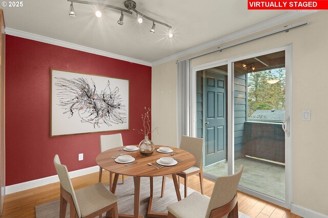 kitchen with stainless steel appliances, light hardwood / wood-style flooring, crown molding, and sink