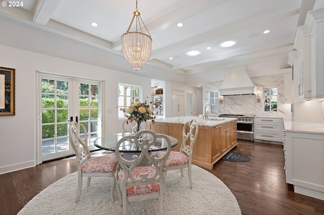 dining room with a chandelier, beam ceiling, sink, and dark hardwood / wood-style floors