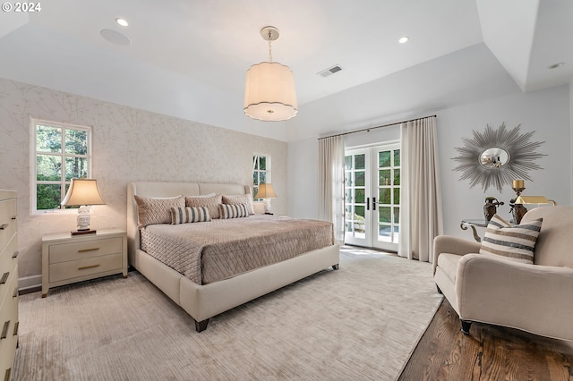 bedroom with hardwood / wood-style flooring, access to outside, and french doors