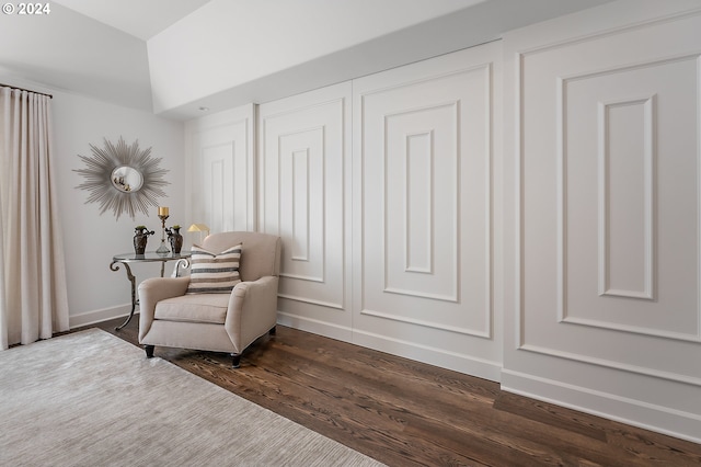 sitting room with dark wood-type flooring