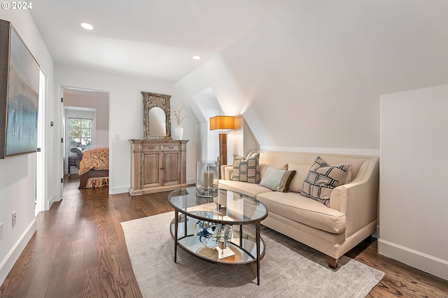 living room featuring vaulted ceiling and dark hardwood / wood-style floors