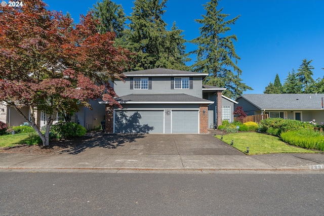 view of front of home featuring a garage and a front lawn