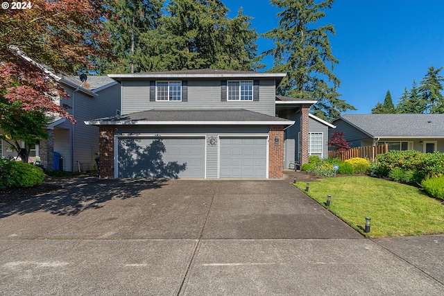 view of property with a front lawn and a garage