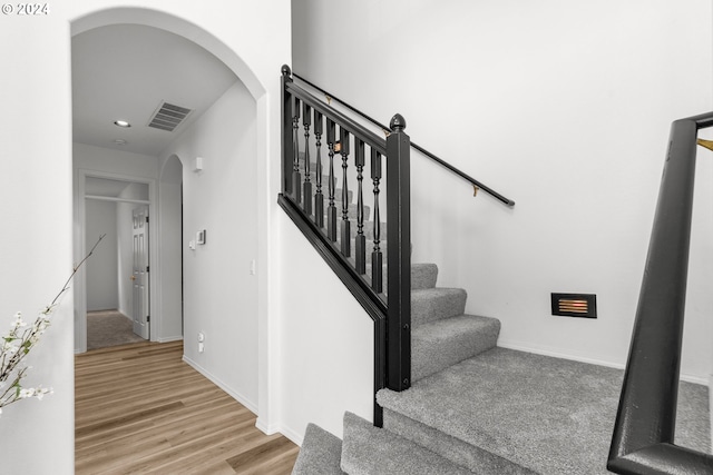 stairway featuring hardwood / wood-style flooring