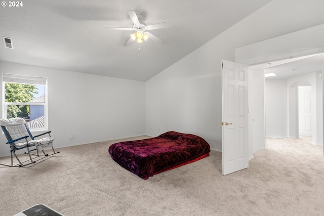 bedroom featuring ceiling fan, light colored carpet, and vaulted ceiling