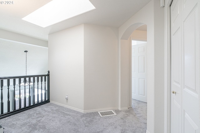 unfurnished bedroom featuring light carpet and a closet