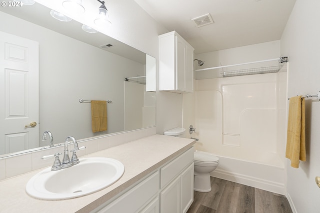 full bathroom with hardwood / wood-style flooring, vanity, toilet, and bathtub / shower combination