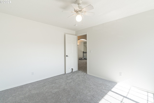 spare room with ceiling fan and carpet floors