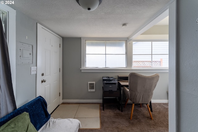 carpeted office with a textured ceiling and heating unit