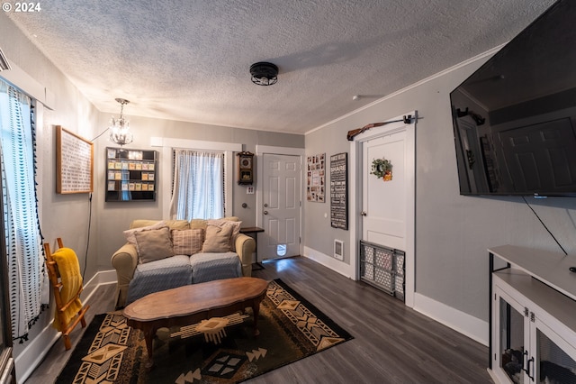 living room with a notable chandelier, dark hardwood / wood-style flooring, and a textured ceiling