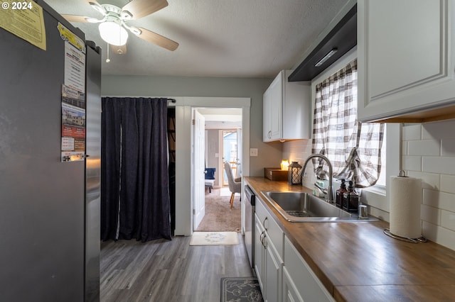 kitchen with white cabinets, plenty of natural light, and hardwood / wood-style flooring