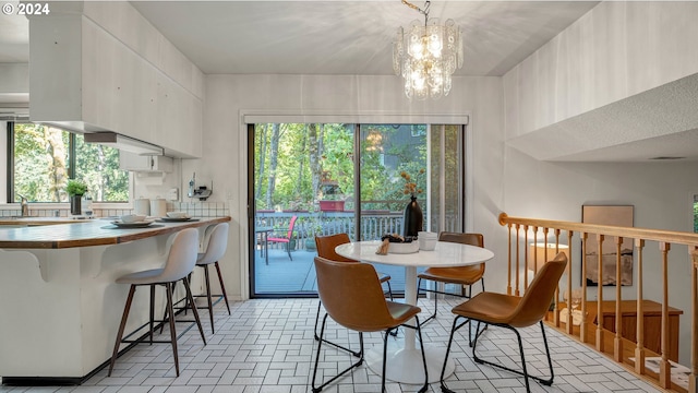 dining space with an inviting chandelier