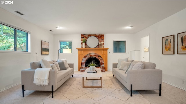 carpeted living room with a brick fireplace